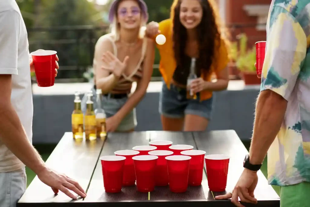 A group of friends is playing beer pong.